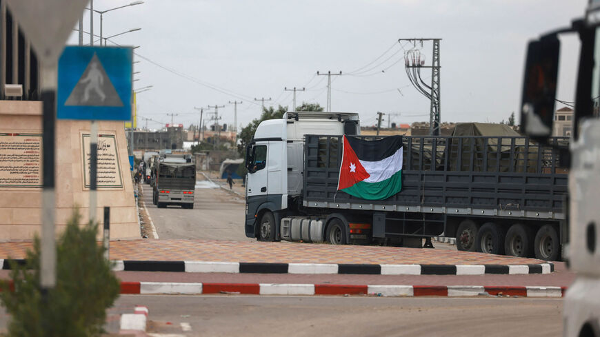 An aid convoy bearing the Jordanian flag enters the Gaza Strip through the Rafah crossing with Egypt, amid ongoing battles between Israel and Hamas, Nov. 20, 2023.