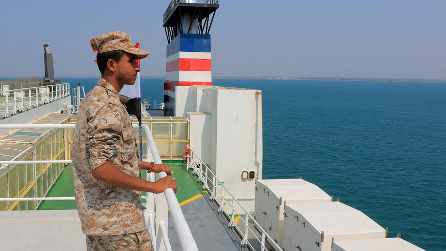 A picture taken during an organized tour by Yemen's Huthi rebels on Nov. 22, 2023, shows a security guard aboard the Galaxy Leader cargo ship, seized by Huthi fighters two days earlier, in a port on the Red Sea in the Yemeni province of Hodeida. 