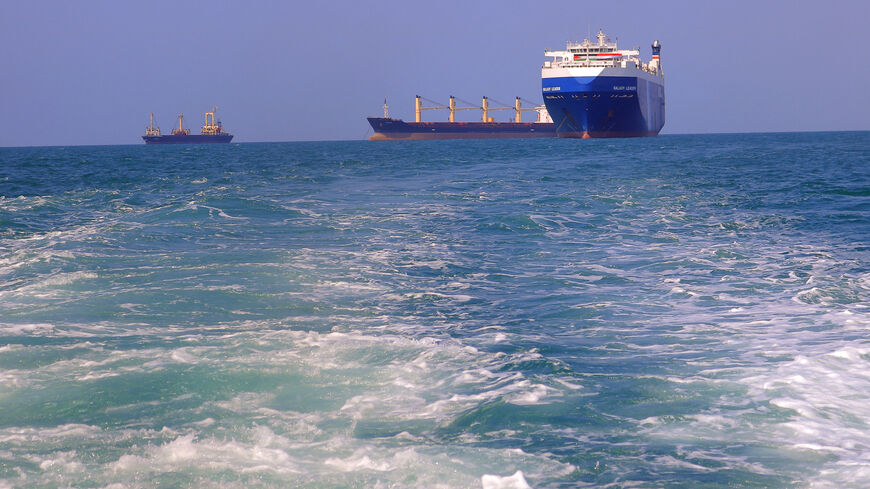 A picture taken during an organised tour by Yemen's Huthi rebels on November 22, 2023 shows the Galaxy Leader cargo ship (R), seized by Huthi fighters two days earlier, approaching the port in the Red Sea off Yemen's province of Hodeida. The Bahamas-flagged, British-owned Galaxy Leader, operated by a Japanese firm but having links to an Israeli businessman, was headed from Turkey to India when it was seized and re-routed to Hodeida November 19, according to maritime security company Ambrey. The Huthis said 