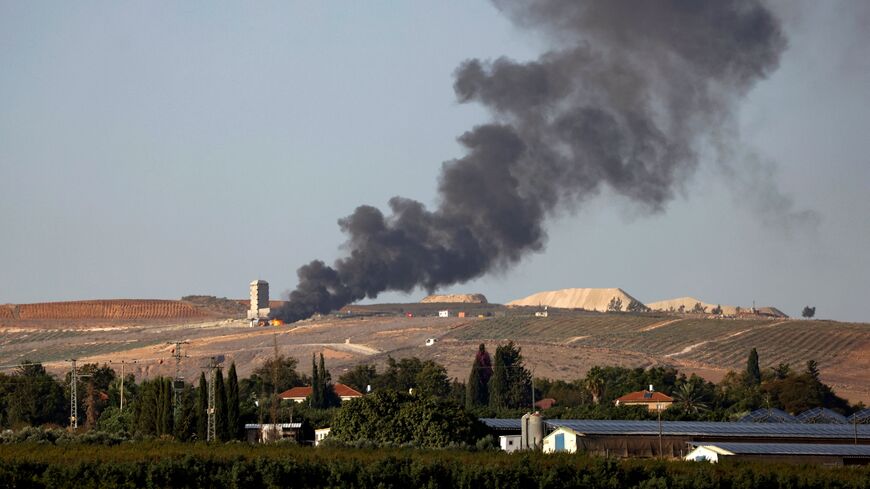 Flames and smoke rise from an agricultural structure in southern Lebanon's Khiam plain following an Israeli bombardment on Nov. 23, 2023.