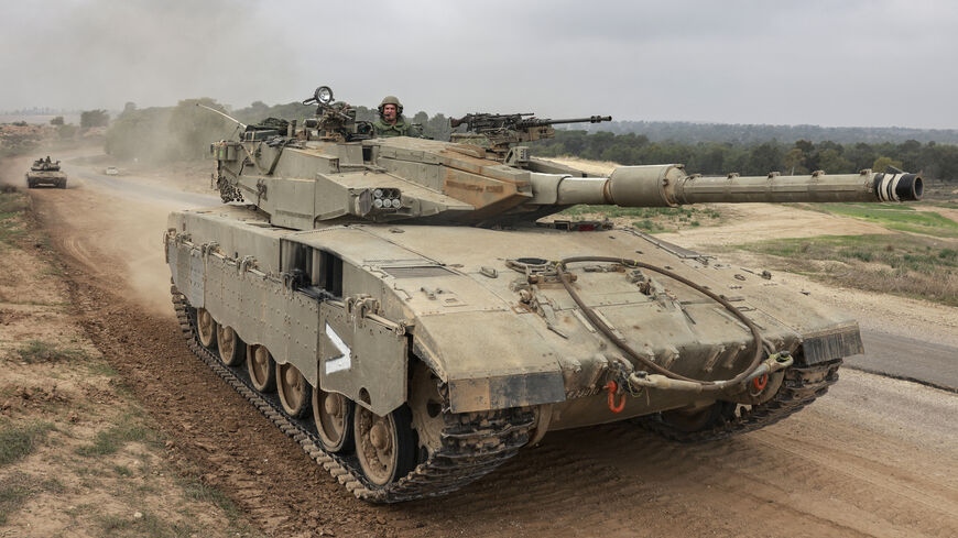 Israeli military tanks roll near the border with the Gaza Strip, amid continuing battles between Israel and Hamas, Dec. 5, 2023.