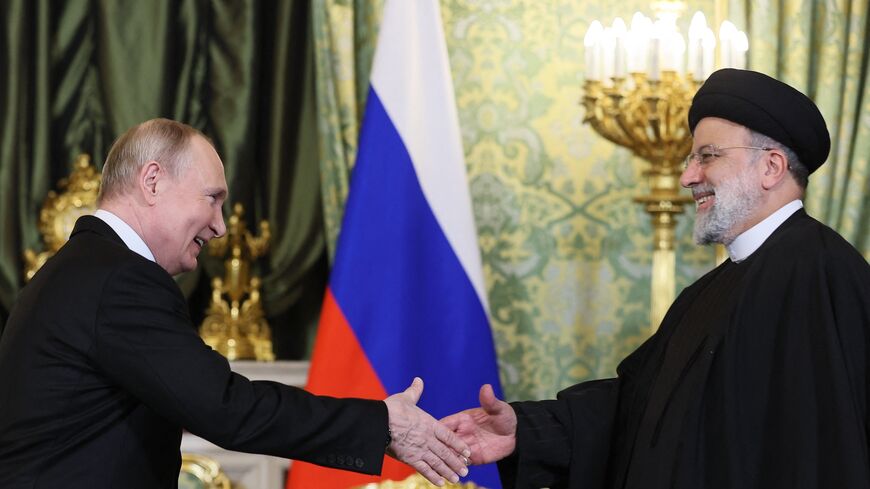 Russia's President Vladimir Putin shakes hands with Iran's President Ebrahim Raisi during their meeting in the Kremlin in Moscow Dec. 7, 2023.