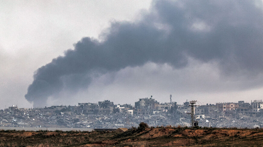 Smoke billows over the northern Gaza Strip during Israeli bombardment from southern Israel on December 27, 2023 amid continuing battles between Israel and the Palestinian militant group Hamas.