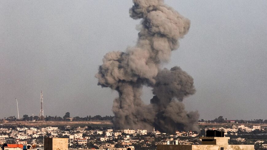 Smoke rises over Khan Yunis, seen from Rafah in the southern Gaza strip, during Israeli bombardment 