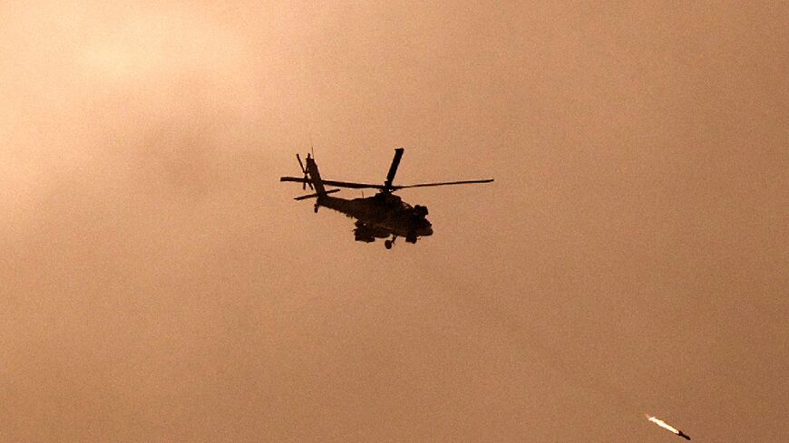 An Israeli military helicopter firing a missile towards Gaza amid battles between Israel and the militant group Hamas