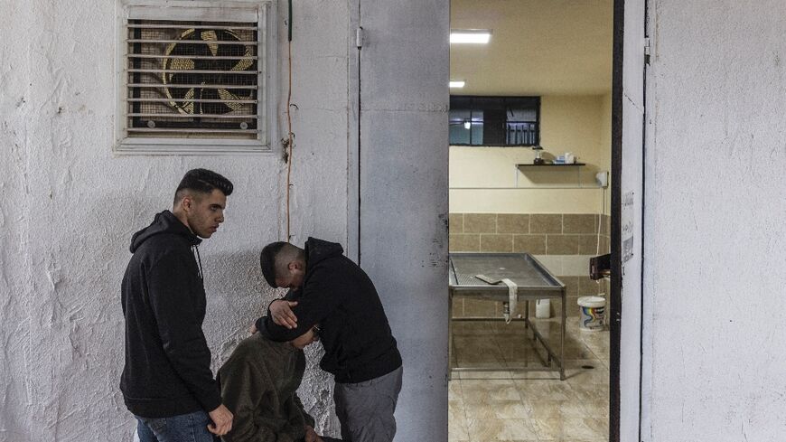 Mourners gather at the morgue where the body of Yamen Mohammed Husseti, 16, was laid ahead of his funeral in the occupied West Bank