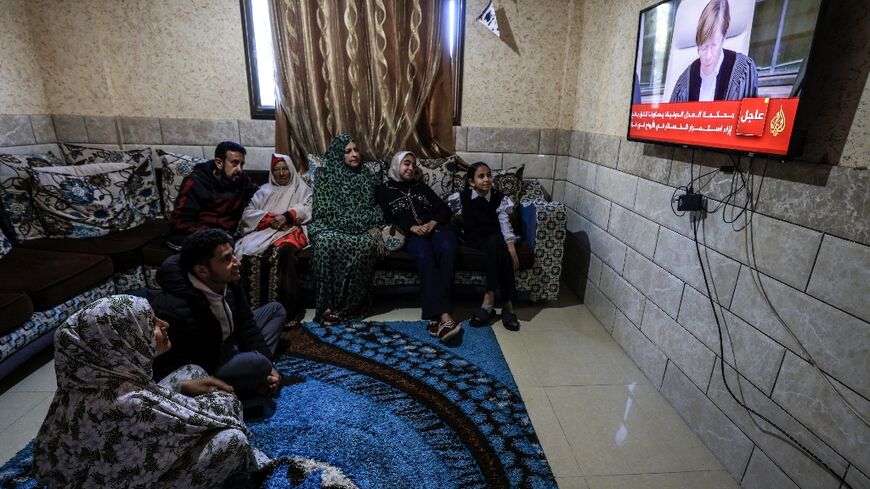 A Palestinian family in Rafah in the Gaza Strip watches on television as the UN's top court in The Hague hands down its initial decision in a case accusing Israel of genocide