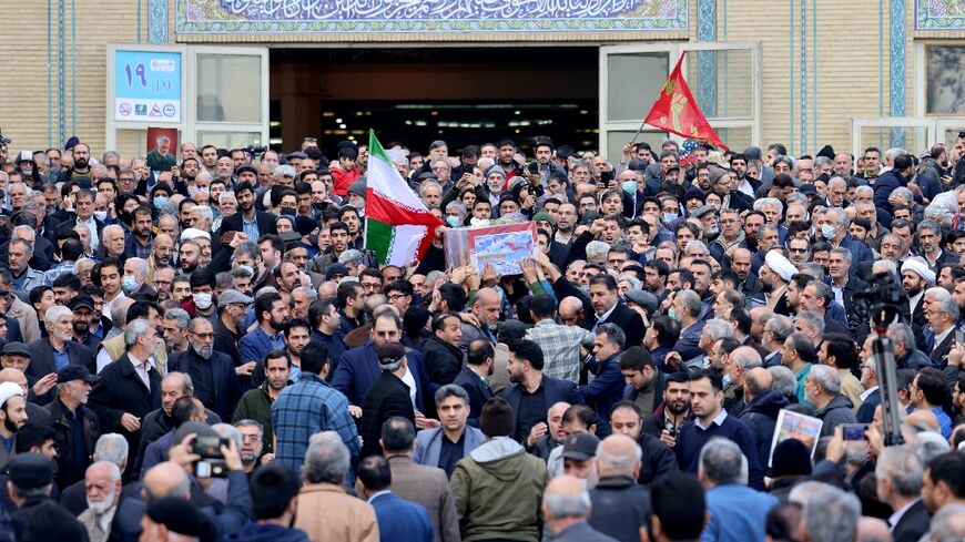 Mourners gather outside a Tehran mosque for the funeral of 89 people killed in twin blasts in the southern city of Kerman claimed by the jihadist Islamic State group