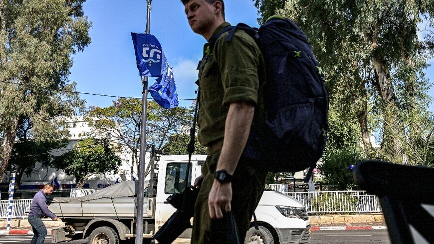 An Israeli soldier walks along a street in Nahariya in northern Israel on January 3, 2024