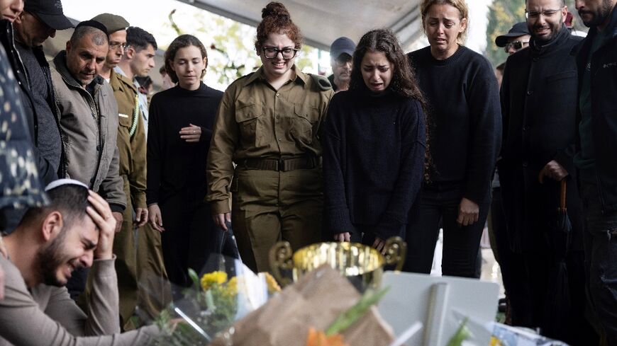 Relatives and friends of an Israeli soldier mourn his death in combat in Gaza during his funeral at the military cemetery in Tel Aviv