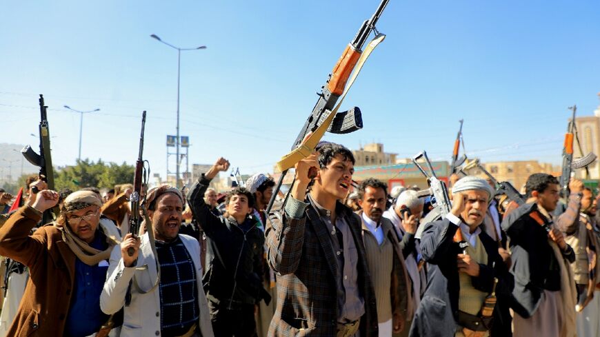 Huthi fighters brandish their weapons during a march in solidarity with the Palestinian people in Yemen's Huthi-controlled capital Sanaa on January 11, 2024