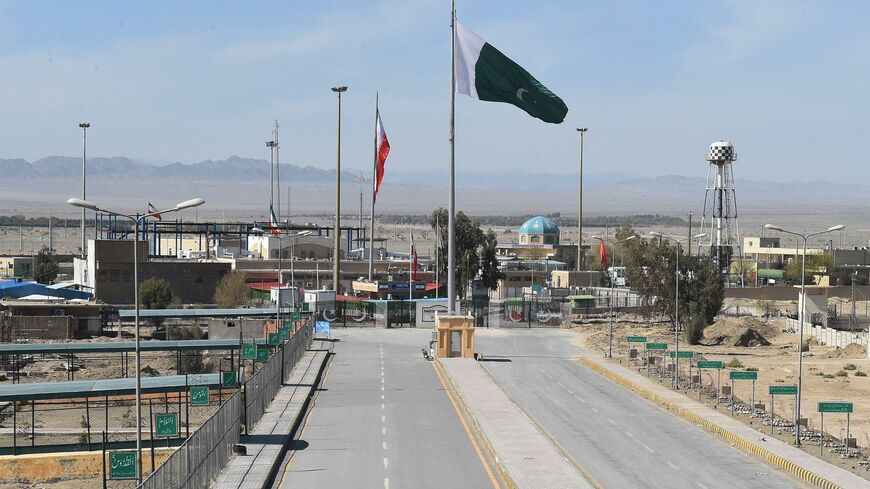 Pakistani and Iranian flags flutter on the closed Pakistan-Iran border in Taftan on February 25, 2020 as fears over the spread of the COVID-19 coronavirus escalate following an outbreak in neighbouring Iran. - The Iranian outbreak where at least 15 people have already died -- the highest death toll in any country outside of China -- has aggravated already frayed nerves in neighbouring Afghanistan and Pakistan. (Photo by Banaras KHAN / AFP) (Photo by BANARAS KHAN/AFP via Getty Images)