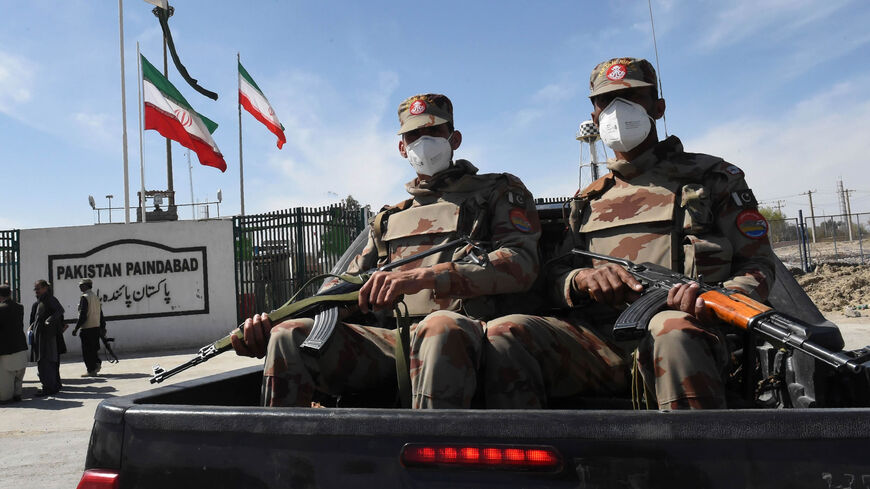 Pakistani soldiers wearing facemasks patrol near the closed Pakistan-Iran border in Taftan, as fears over the spread of the coronavirus escalate following an outbreak in neighboring Iran, Feb. 25, 2020.