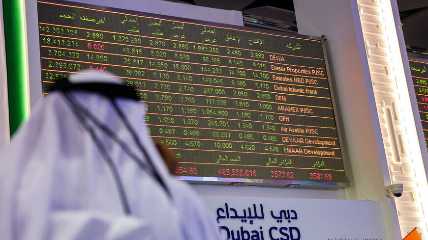 A man watches stock movements on a display at the Dubai Financial Market stock exchange in the Gulf emirate on April 12, 2022. Shares in the Dubai Electricity and Water Authority (DEWA) rose 16 percent on April 12 in the Gulf region's biggest initial public offering since Saudi oil giant Aramco in 2019. (Photo by Giuseppe CACACE / AFP) (Photo by GIUSEPPE CACACE/AFP via Getty Images)