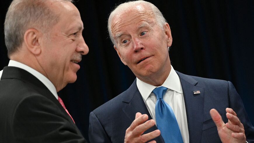 TOPSHOT - Turkey's President Recep Tayyip Erdogan speaks with US President Joe Biden at the start of the first plenary session of the NATO summit at the Ifema congress centre in Madrid, on June 29, 2022. (Photo by GABRIEL BOUYS / AFP) (Photo by GABRIEL BOUYS/AFP via Getty Images)