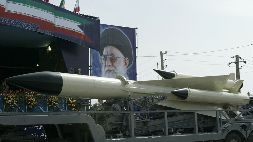 An Iranian navy missile is displayed during the army day military parade, outside the mausoleum of the late founder of Islamic republic, Ayatollah Khomeini (poster) in Tehran, April 18, 2007.