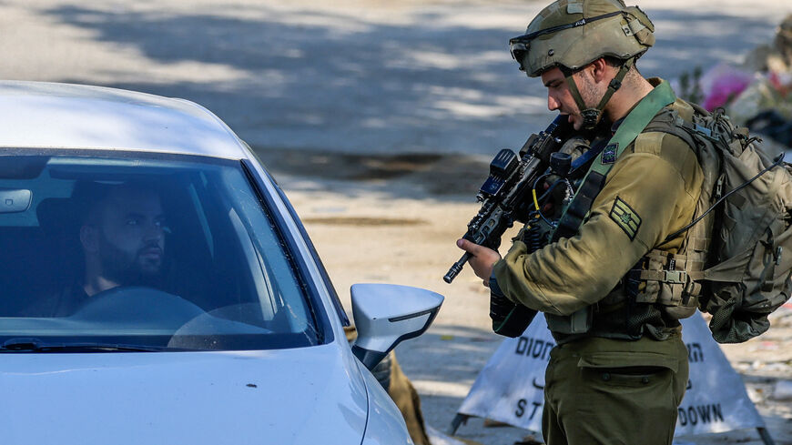 An Israeli soldier stops a driver at a checkpoint at the entrance of the Palestinian village of Orif, south of Nablus in the northern West Bank, on June 22, 2023, following an incursion by Israeli forces into the village. (Photo by Jaafar ASHTIYEH / AFP) (Photo by JAAFAR ASHTIYEH/AFP via Getty Images)