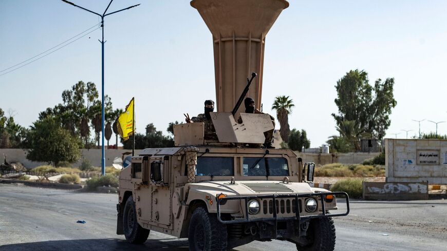 A vehicle of the Syrian Democratic Forces (SDF) is pictured along a road as fighters deploy to impose a curfew in the town of al-Busayrah in Syria's northeastern Deir Ezzor province on September 4, 2023, during a guided media tour organised by the SDF. Days of deadly clashes between the US-backed, Kurdish-led Syrian Democratic Forces (SDF) and local fighters have rocked Deir Ezzor, threatening a fragile balance in the strategic area.