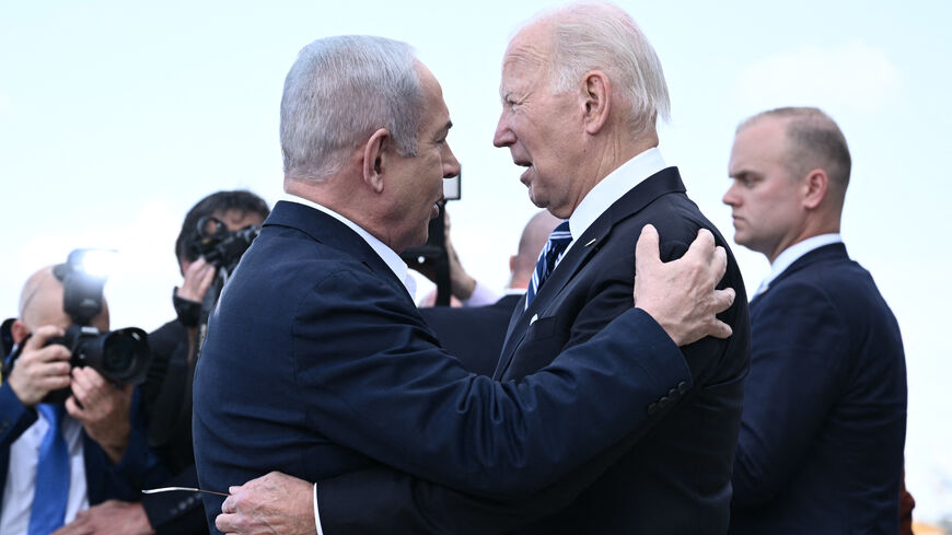 Israel Prime Minister Benjamin Netanyahu (L) greets US President Joe Biden upon his arrival at Tel Aviv's Ben Gurion airport on Oct. 18, 2023, amid the ongoing battles between Israel and the Palestinian group Hamas. 
