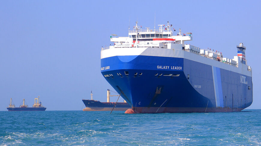A picture taken during an organised tour by Yemen's Huthi rebels on November 22, 2023 shows the Galaxy Leader cargo ship (R), seized by Huthi fighters two days earlier, approaching the port in the Red Sea off Yemen's province of Hodeida. The Bahamas-flagged, British-owned Galaxy Leader, operated by a Japanese firm but having links to an Israeli businessman, was headed from Turkey to India when it was seized and re-routed to Hodeida November 19, according to maritime security company Ambrey. The Huthis said 