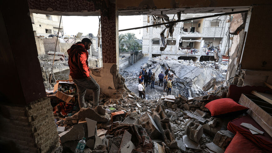 A man inspects the destroyed building of Palestinian journalist Adel Zorob, who was killed overnight in an Israeli bombardment, in Rafah in the southern Gaza Strip on Dec. 19, 2023, amid continuing battles between Israel and the Palestinian Hamas militant group.  