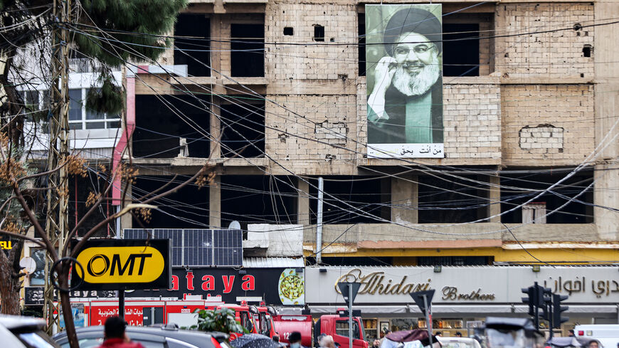 A picture depicting Hassan Nasrallah, the leader of the Lebanese Shiite movement Hezbollah, hangs on a building near the site of a drone strike attributed to Israel targeting Hamas deputy leader Saleh al-Aruri in the southern suburb of Beirut on Jan. 3, 2024.