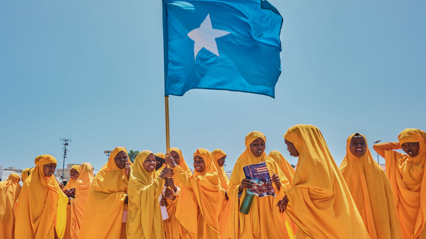 TOPSHOT - Students wave a Somali flag during a demonstration in support of Somalia's government following the port deal signed between Ethiopia and the breakaway region of Somaliland at Eng Yariisow Stadium in Mogadishu on January 3, 2024. Somalia vowed to defend its territory after a controversial Red Sea access deal between Ethiopia and the breakaway state of Somaliland that it branded as "aggression". (Photo by ABDISHUKRI HAYBE / AFP) (Photo by ABDISHUKRI HAYBE/AFP via Getty Images)