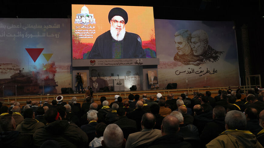 People watch the televised speech of Lebanon's Hezbollah chief Hasan Nasrallah to mark the anniversary of the killing of slain top Iranian commander Qasem Soleimani, in a Beirut's southern suburb on Jan. 3, 2024. 