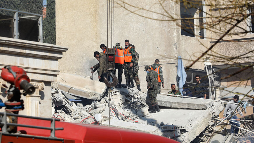 Security and emergency personnel search the rubble of a building destroyed in a reported Israeli strike in Damascus on January 20, 2024. An Israeli strike on Damascus killed the Iranian Revolutionary Guards' intelligence chief for Syria and three other Guards members on January 20, Iran said, in an attack that tore into a multi-storey residential building. (Photo by Louai BESHARA / AFP) (Photo by LOUAI BESHARA/AFP via Getty Images)