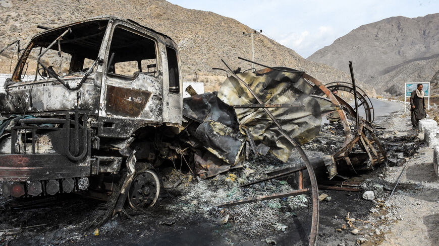 A man walks past a charred truck container torched by armed separatist group Balochistan Liberation Army (BLA) at central Bolan district in Balochistan province on January 30, 2024. At least six militants were killed in an overnight gun battle with security forces in western Pakistan's Balochistan province, an official said on January 30. (Photo by Banaras KHAN / AFP) (Photo by BANARAS KHAN/AFP via Getty Images)