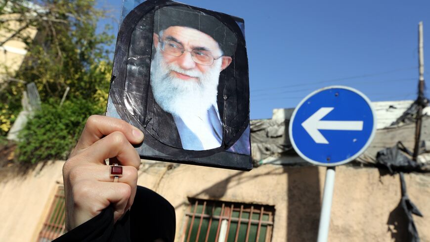 An Iranian woman holds a portrait of Iran's supreme leader Ayatollah Ali Khamenei duringa demonstration against the Saudi-led coalitions Operation Decisive Storm against the Huthi rebels in Yemen, outside the Saudi embassy in Tehran on April 13, 2015. AFP PHOTO/ATTA KENARE (Photo credit should read ATTA KENARE/AFP via Getty Images)