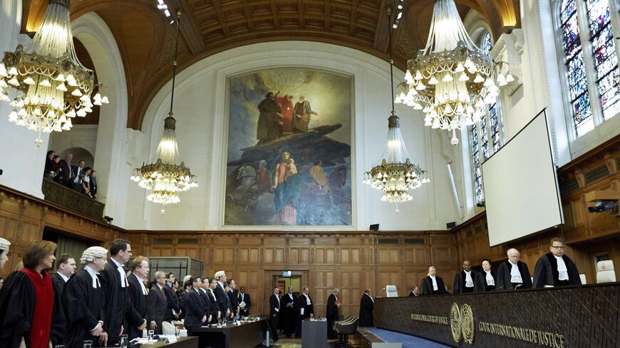 Judges enter the courtroom prior to the verdict in the case against Japanese whaling at the International Court of Justice (ICJ) in The Hague, the Netherlands, on March 31, 2014. The UN's top International Court of Justice will rule today whether Japan has the right to hunt whales in the Antarctic, in an emotive case activists say is make-or-break for the giant mammal's future. AFP PHOTO / ANP / MARTIJN BEEKMAN ***Netherlands out*** (Photo credit should read Martijn Beekman/AFP via Getty Images)