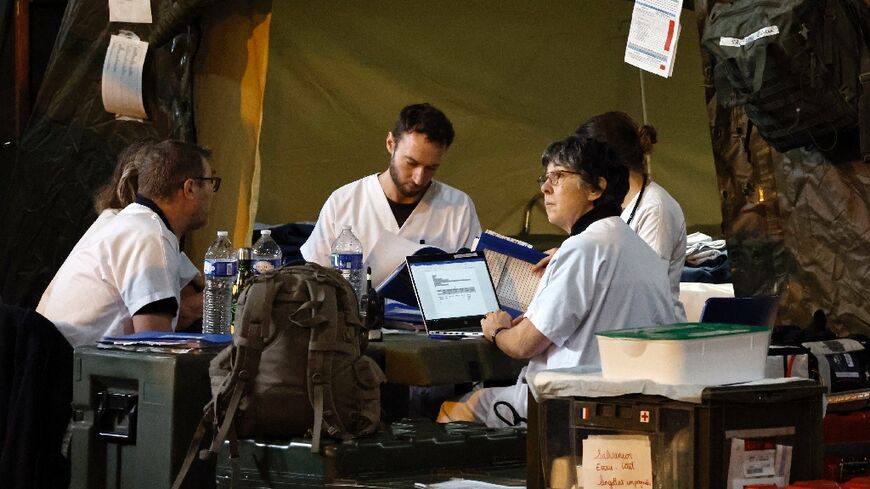 Military medical staff work aboard the French warship