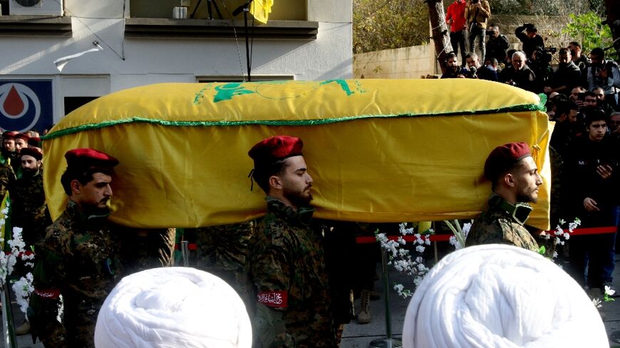 Hezbollah militants carry the coffin of Wissam Tawil during his funeral in Khirbit Silm