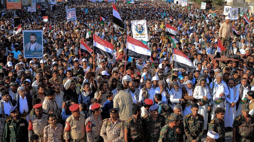 People take part in a protest in the streets of the Yemeni Red Sea city of Hudeida, to condemn US and British strikes on Huthi rebel-held cities, on January 12, 2024