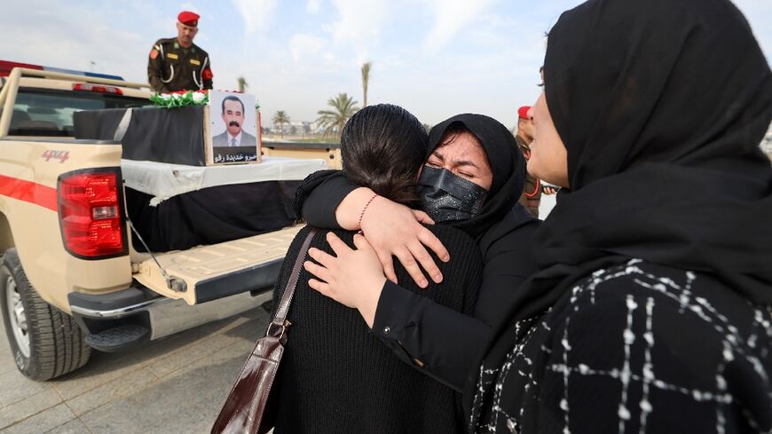 Relatives mourn during a solemn funeral ceremony for the 41 victims from the Yazidi minority who were executed by Islamic State group militants in 2014
