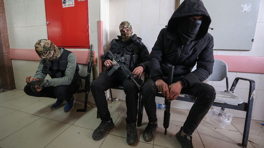 Armed Palestinian militants wait for the funerals of three Palestinians killed in an Israeli raid on the Faraa refugee camp near the West Bank town of Tubas