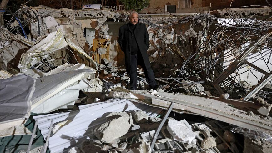 Palestinian activist Fakhri Abu Diab stands amid the rubble of his home that was demolished by Jerusalem municipality workers in the mostly Arab east Jerusalem neighbourhood of Silwan on February 14, 2024