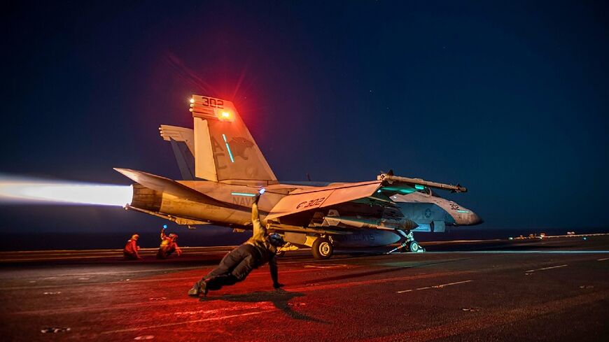 This image released by US Central Command on February 24, 2024 shows a fighter plane launching from the deck of the USS Eisenhower aircraft carrier in the Red Sea during operations against Huthi targets