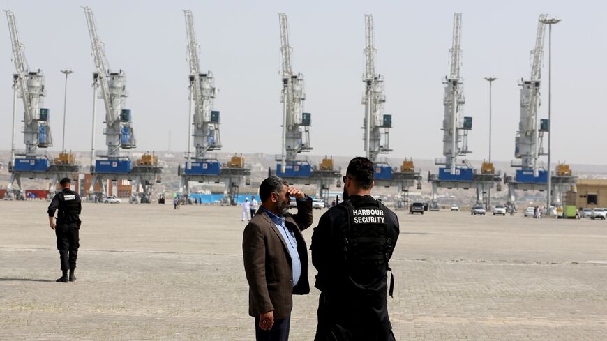 Harbor security stands guard during an inauguration ceremony of new equipment and infrastructure at Shahid Beheshti Port.