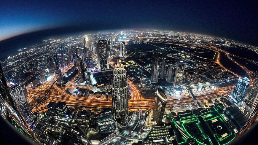 This picture taken with a fish-eye lens on May 9, 2021 shows a view of the Dubai city skyline as seen from the Burj Khalifa, currently the world's tallest building at 828 meters.