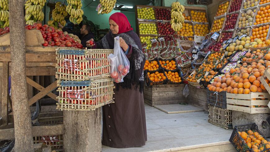 An Egyptian woman shops at a fruit market in Cairo, on March 17, 2022.