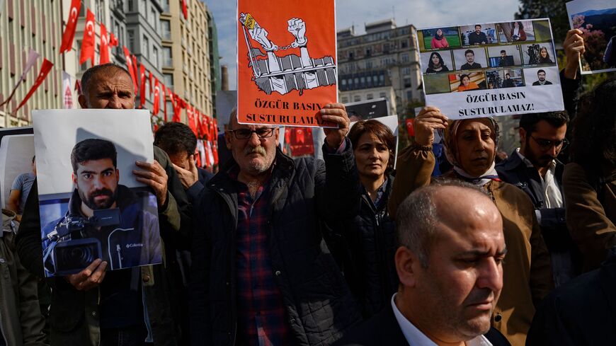 People take part in a protest against the arrest of nine journalists working for Kurdish media outlets including Mezopotamya news agency in Istanbul, on Oct. 31, 2022. 
