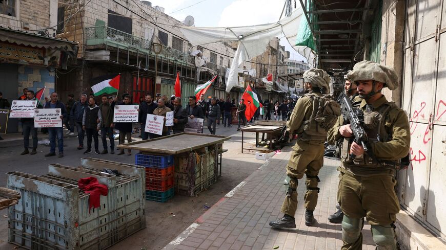 Members of the Israeli security forces stand guard as activists demonstrate against the presence of Israeli settlers in Hebron and to commemorate the 1994 Ibrahimi Mosque massacre, in the centre of the West Bank town, on Feb. 24, 2023. 