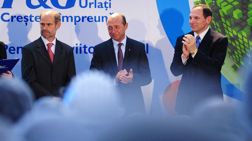(To go with AFP story by Mihaela Rodina) Urlati Plant Manager, Luc Viaene (L), Romanian President Traian Basescu (C) and Bob MacDonald (R), President and Chief Executive Officer of P&G, stand together during the official inauguration of a new Procter & Gamble plant in Urlati, a city 80km northeast from Bucharest, on September 29, 2010. The new factory will produce hair care products, of which 90 percent will be exported throughout the European Union and Turkey. AFP PHOTO/DANIEL MIHAILESCU (Photo by DANIEL M