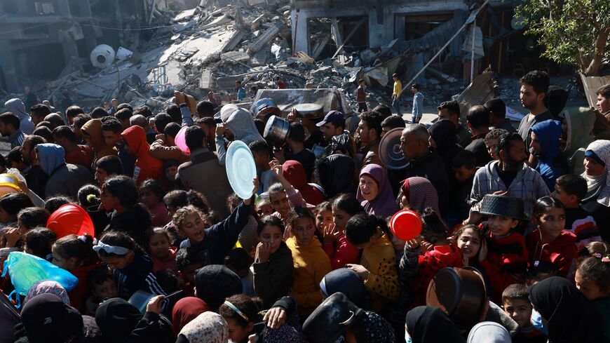Displaced Palestinians queue for food donations in the southern Gaza Strip city of Rafah, on Nov. 30, 2023.