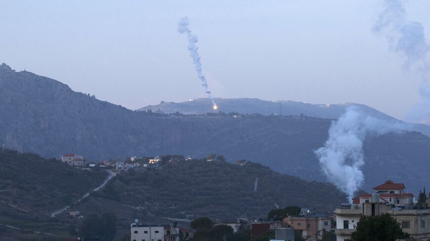Smoke billows from an Israeli airstrike as flares fall on the southern Lebanese village of Kfar Kila, near the border with Israel, Jan. 19, 2024.