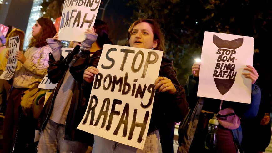 Demonstrators gather with signs during a protest by Israeli left-wing activists against the war in the Gaza Strip and the planned ground operation in Rafah, on Feb. 13, 2024.