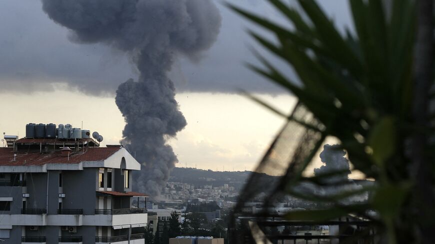 Smoke billows following two Israeli air raids (L and R) in the southern Lebanese city town of Ghaziyeh.