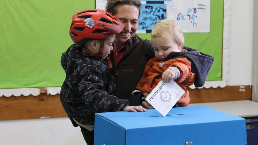 An Israeli woman casts her vote in Jerusalem in municipal elections that may offer a gauge of the public mood nearly five months into the Gaza war